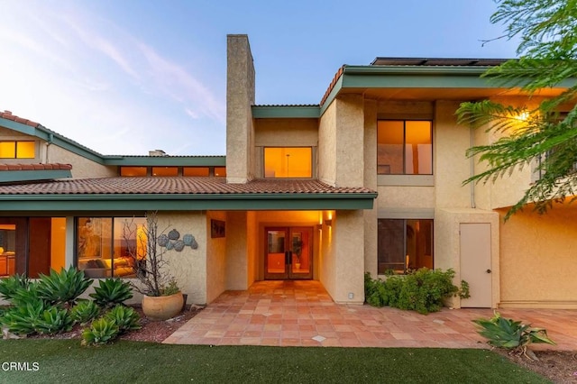 rear view of property with french doors