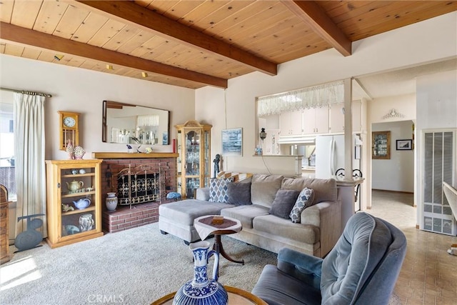 living room with beamed ceiling, a fireplace, and wood ceiling