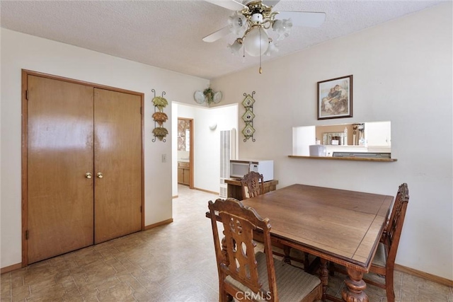 dining space featuring a textured ceiling and ceiling fan