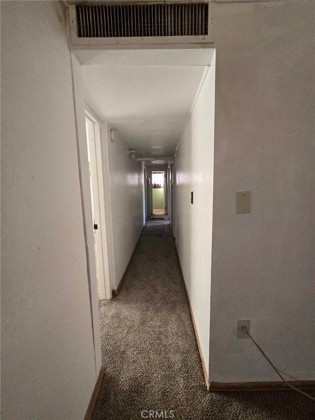 corridor featuring dark carpet