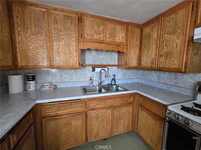 kitchen with sink, tasteful backsplash, and white stove