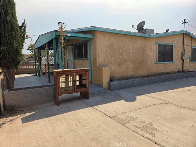 view of property exterior featuring a patio