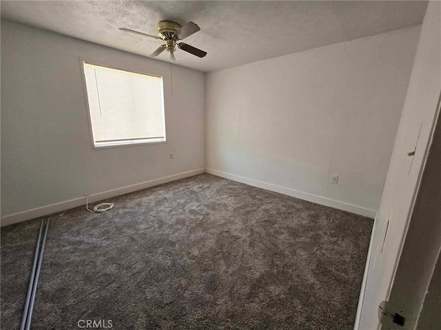 unfurnished room featuring dark carpet, a textured ceiling, and ceiling fan