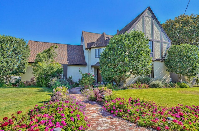 tudor house with a front lawn