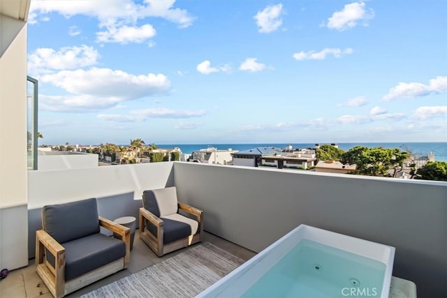 balcony featuring a water view