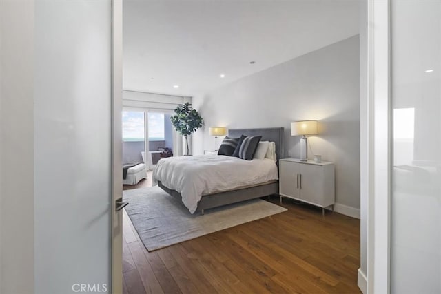 bedroom with dark wood-type flooring