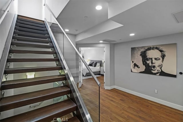 staircase featuring hardwood / wood-style flooring