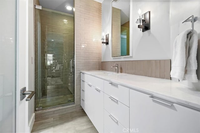 bathroom featuring walk in shower and vanity