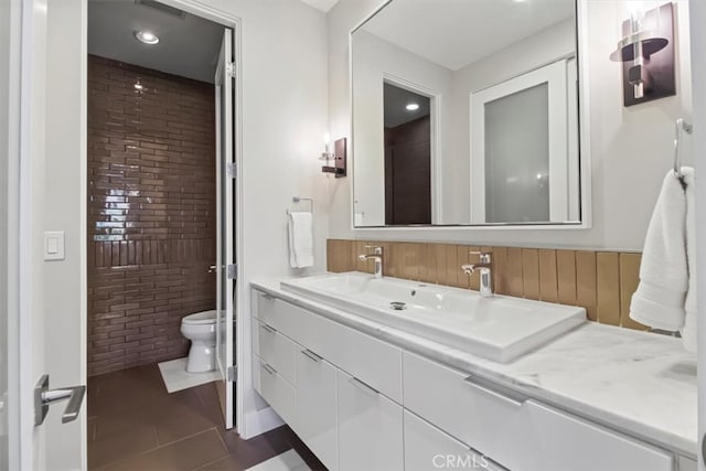 bathroom with vanity, toilet, and tile patterned floors