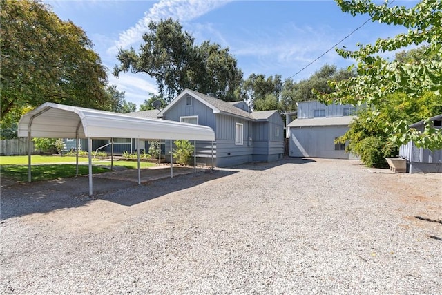 view of front of house with gravel driveway and a detached carport