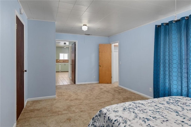 carpeted bedroom with baseboards, ensuite bathroom, and visible vents