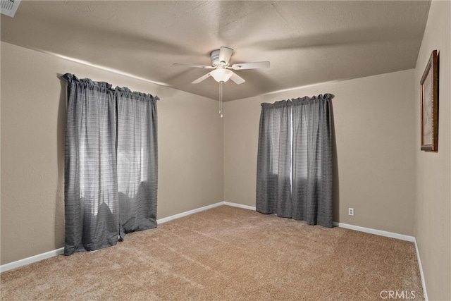 carpeted spare room with ceiling fan and a textured ceiling