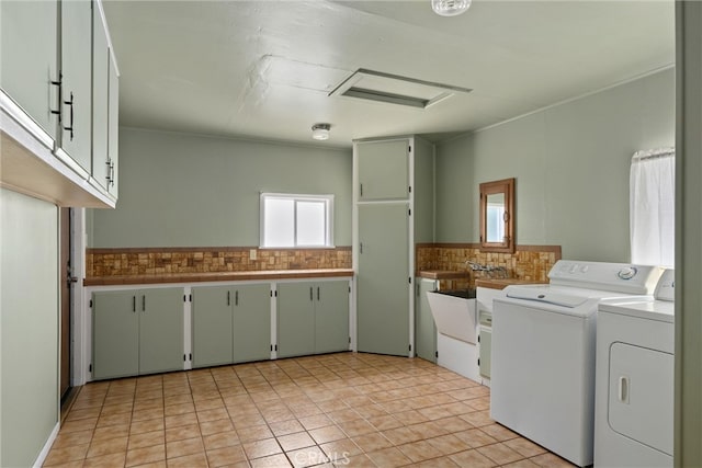 clothes washing area with light tile patterned floors and washing machine and clothes dryer