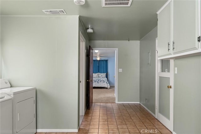 clothes washing area featuring cabinet space, visible vents, washer and dryer, and light tile patterned floors