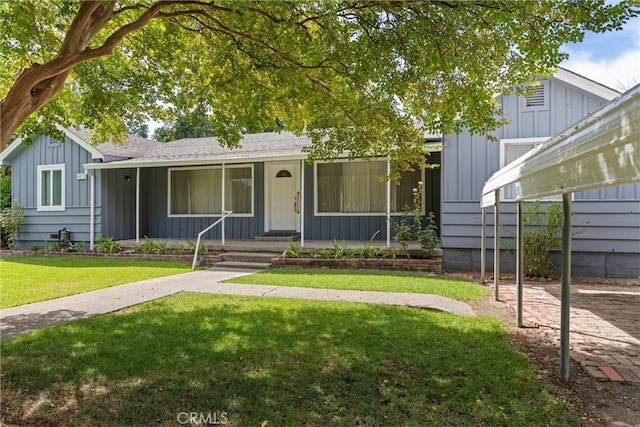 single story home featuring board and batten siding and a front yard