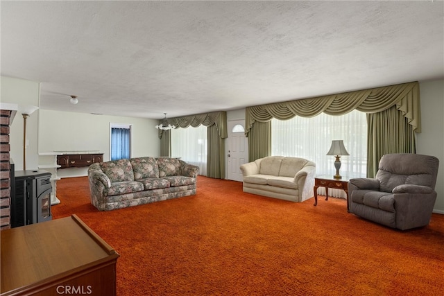 living room with a textured ceiling, carpet flooring, and a chandelier