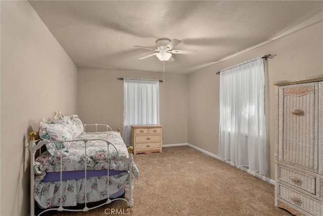 bedroom with ceiling fan, carpet floors, and baseboards