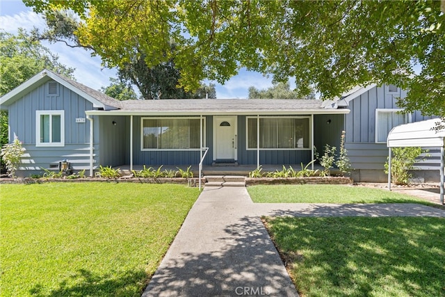 ranch-style home featuring a front lawn and covered porch