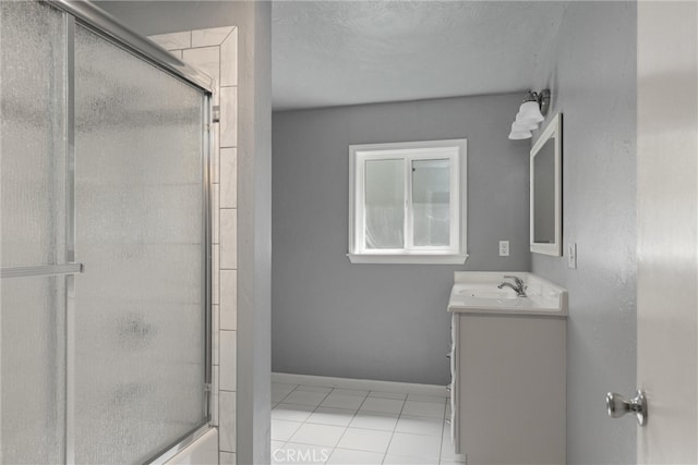 bathroom with vanity, tile patterned floors, and a shower with shower door