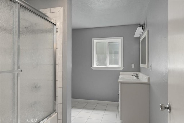 full bath featuring tile patterned flooring, baseboards, vanity, and an enclosed shower