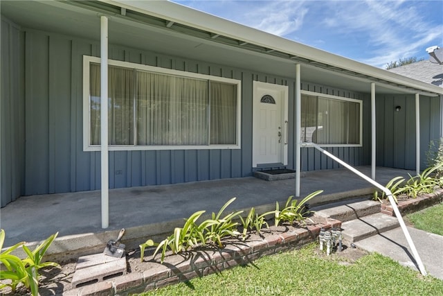 view of exterior entry featuring a porch