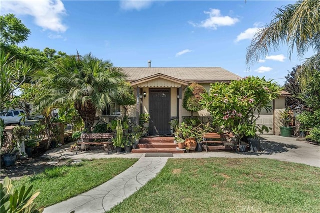 view of front of property with a front lawn and a garage