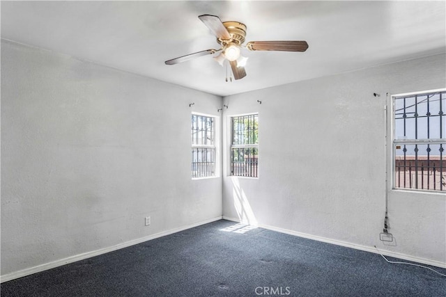 carpeted empty room featuring ceiling fan