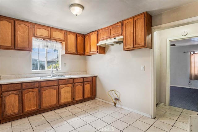 kitchen featuring light tile patterned floors and sink