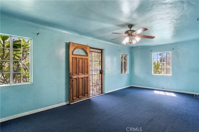 unfurnished room featuring carpet flooring, ceiling fan, and plenty of natural light