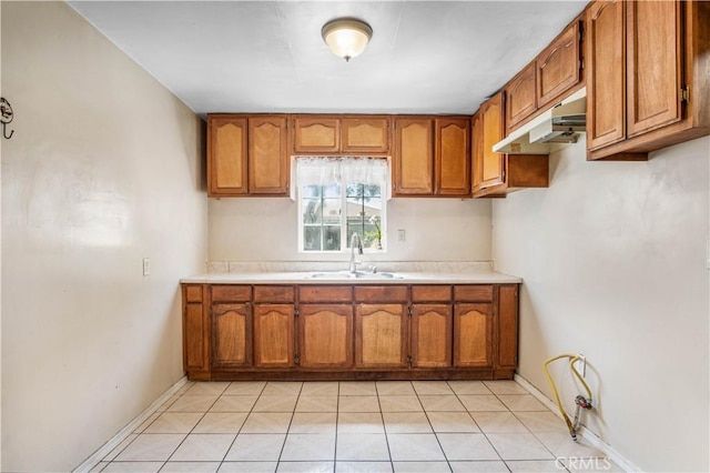 kitchen with light tile patterned floors and sink