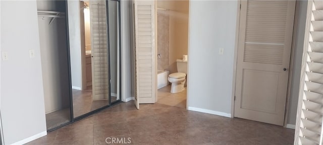 bathroom with toilet and tile patterned floors