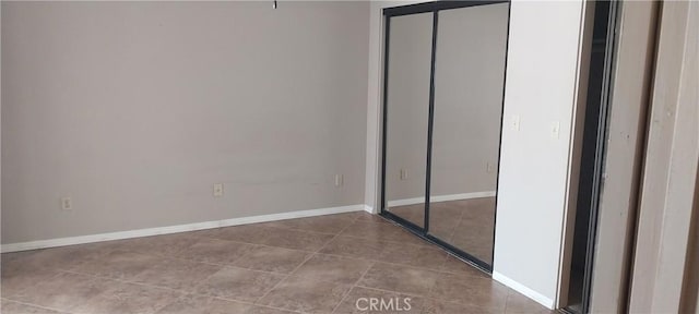 67130 Garbino Rd, Cathedral City, CA 92234 - unfurnished bedroom with baseboards, tile patterned floors, and a closet