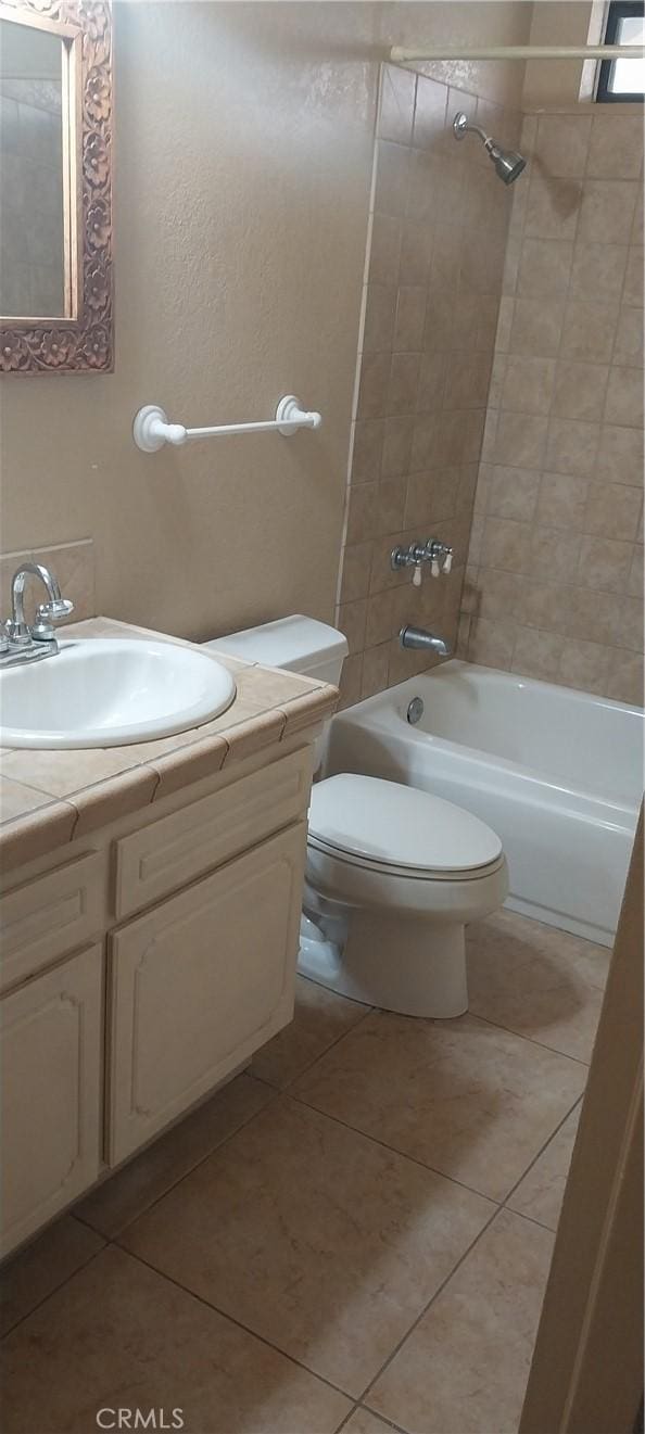 67130 Garbino Rd, Cathedral City, CA 92234 - bathroom with vanity, tile patterned floors, toilet, and tub / shower combination
