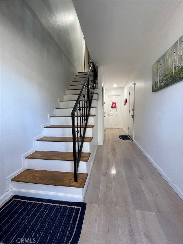 stairway featuring hardwood / wood-style floors