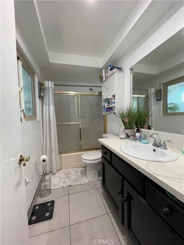 full bathroom with shower / bath combination with curtain, vanity, toilet, and a healthy amount of sunlight