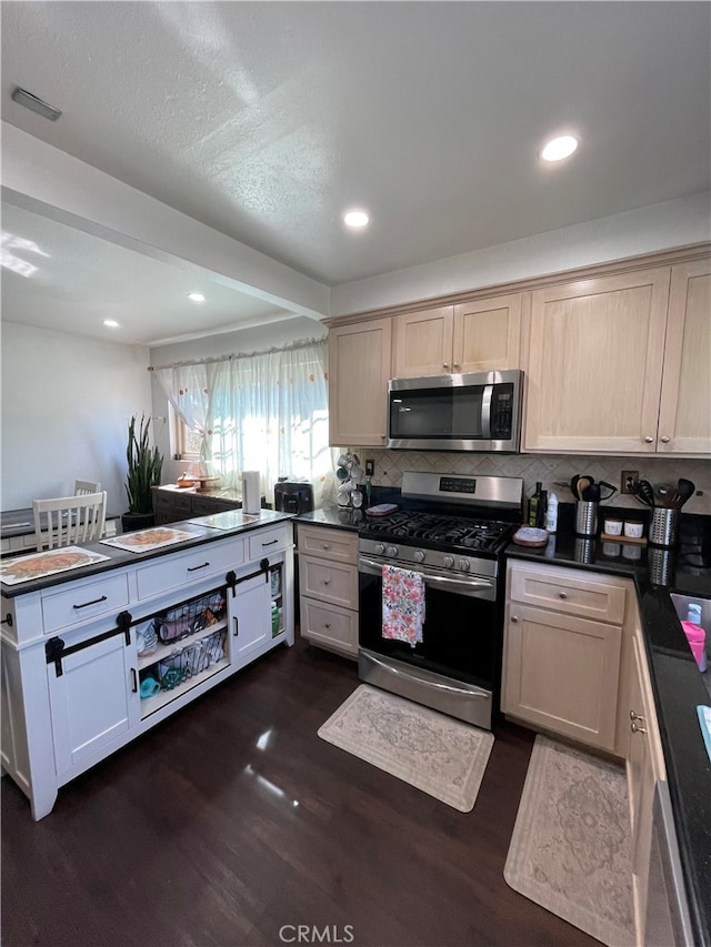 kitchen with light brown cabinets, decorative backsplash, dark hardwood / wood-style floors, and stainless steel appliances