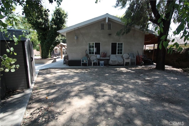 back of property featuring a patio area