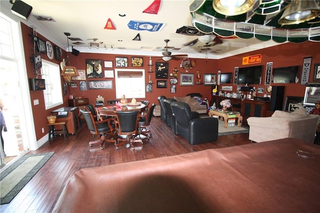 living area featuring ceiling fan, ornamental molding, and dark wood-style flooring