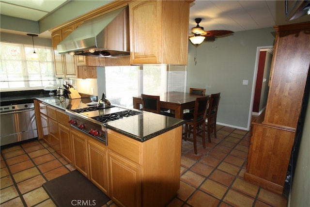 kitchen featuring dark tile patterned floors, a wealth of natural light, and wall chimney range hood