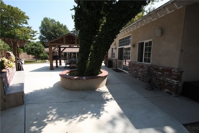 view of patio with a gazebo and a pergola