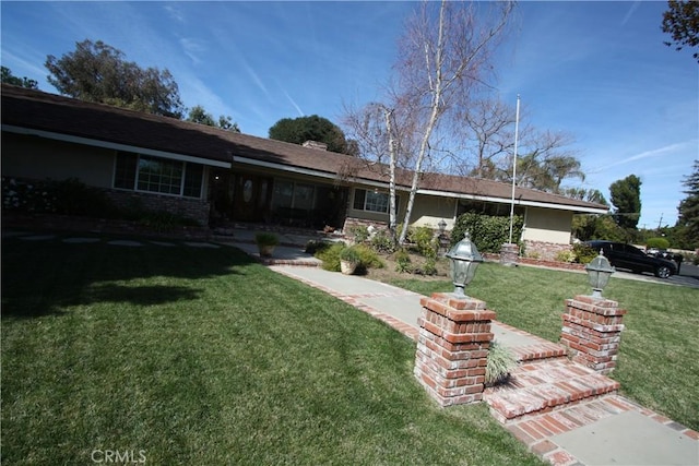 single story home featuring a front yard