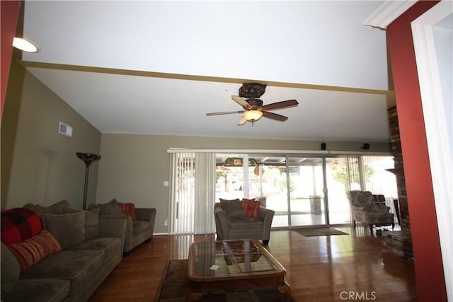 living area with lofted ceiling, dark wood-style floors, visible vents, and a ceiling fan