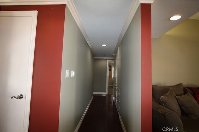 hall with dark wood-style floors, baseboards, ornamental molding, and recessed lighting