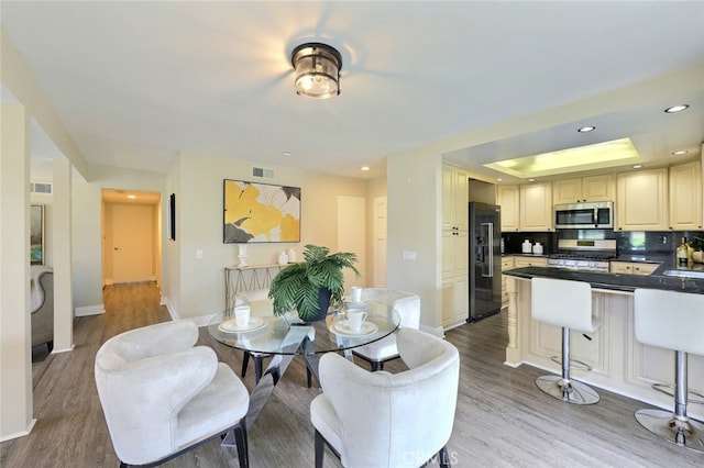 dining space with hardwood / wood-style floors and sink