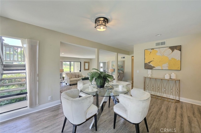 dining space with hardwood / wood-style flooring