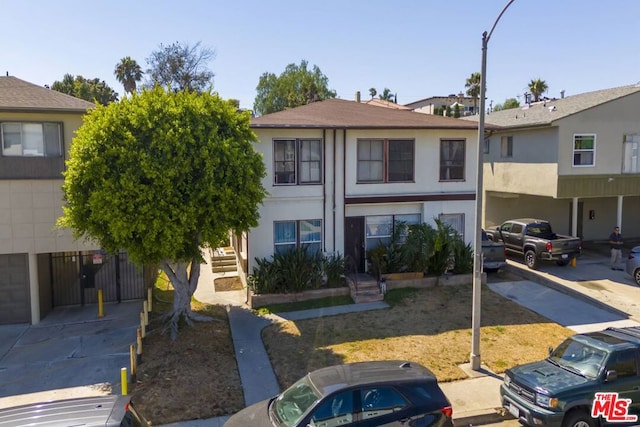 multi unit property featuring a garage