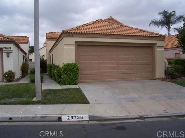 mediterranean / spanish-style home with a garage