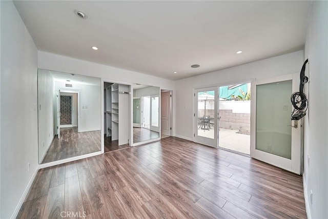 empty room with hardwood / wood-style flooring and french doors