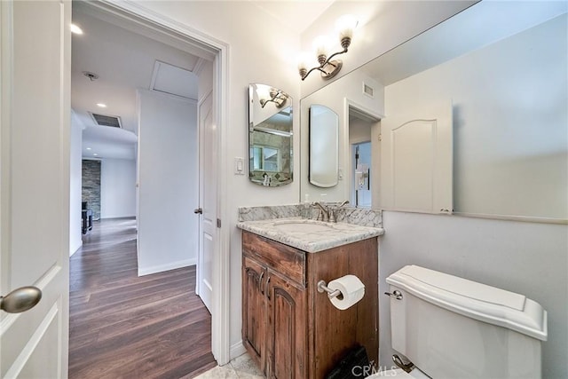 bathroom featuring vanity, toilet, and a fireplace