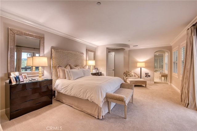 bedroom featuring arched walkways, carpet flooring, baseboards, and ornamental molding